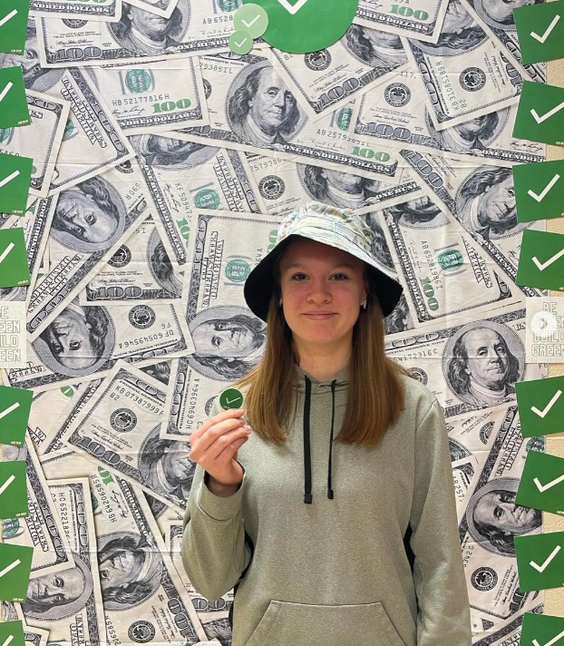 Green Money Wall with Student